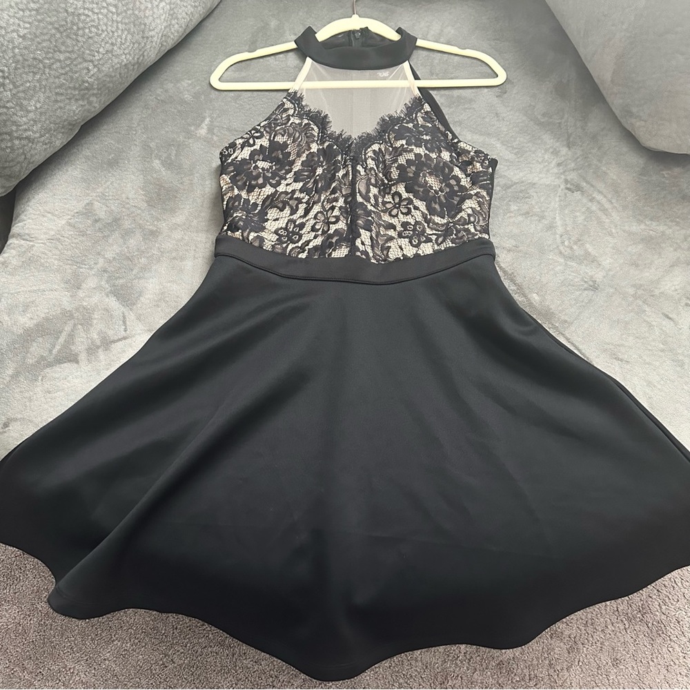 This is a black, formal dress with a floral design.
